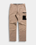 Khaki pants with black patch on a light gray background
