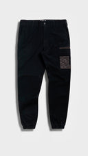 Black jogger cargo work pants with a patch on a white background. cuffed hem with multiple functional nylon fabric reinforced panels to ensure durability