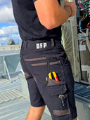 Person wearing DFP work pants on a rooftop with HVAC equipment in the background
